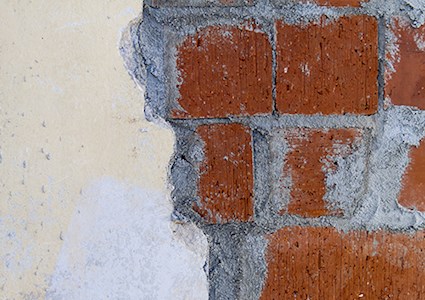 Close up of wall with exposed brick and mortar