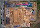 Aerial view of construction site with building materials stacked around two structures under construction