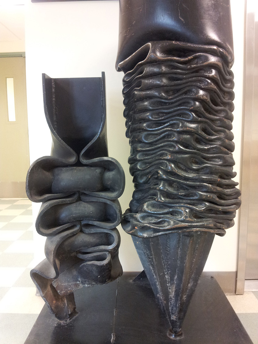 A display case highlights two steel piles damaged when trying to drill in permafrost.