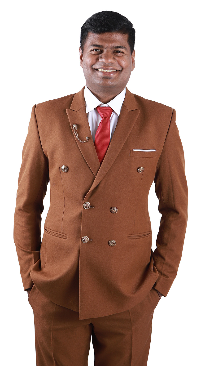 A man in a suit smiles at the camera.