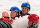 three people practice swift water rescue with a dummy